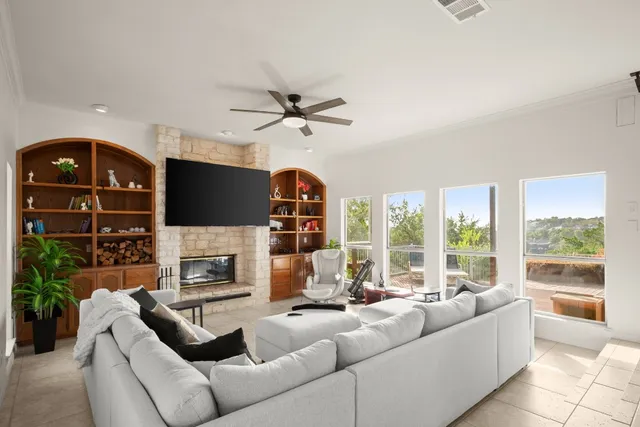 a living room with furniture a fireplace and a flat screen tv