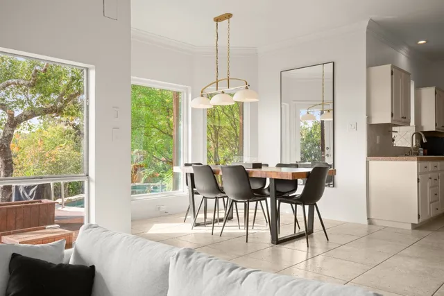 a dining room with furniture a chandelier and wooden floor