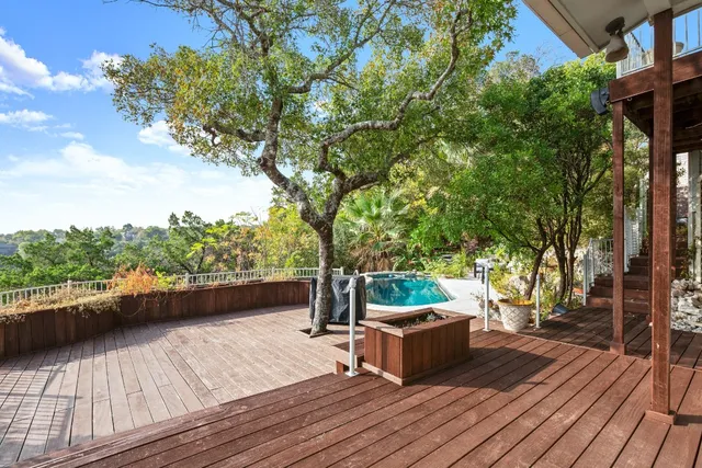 a view of a couches on a deck with a floor to ceiling window
