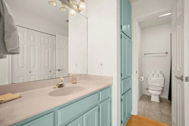 a bathroom with a sink toilet a mirror and shower