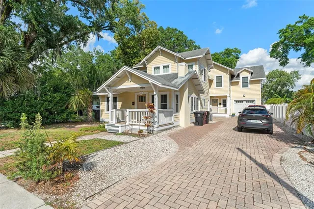 a front view of a house with swimming pool and sitting area