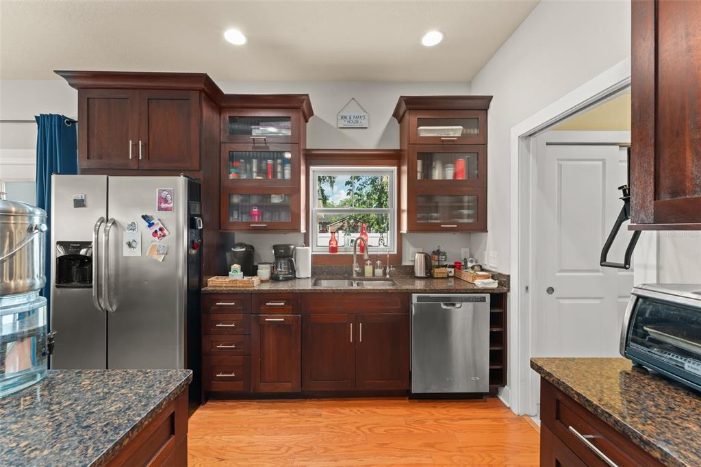2223 Amherst Avenue Orlando, FL 32804 - Photo 13 of 64 a kitchen with stainless steel appliances granite countertop a refrigerator and a stove