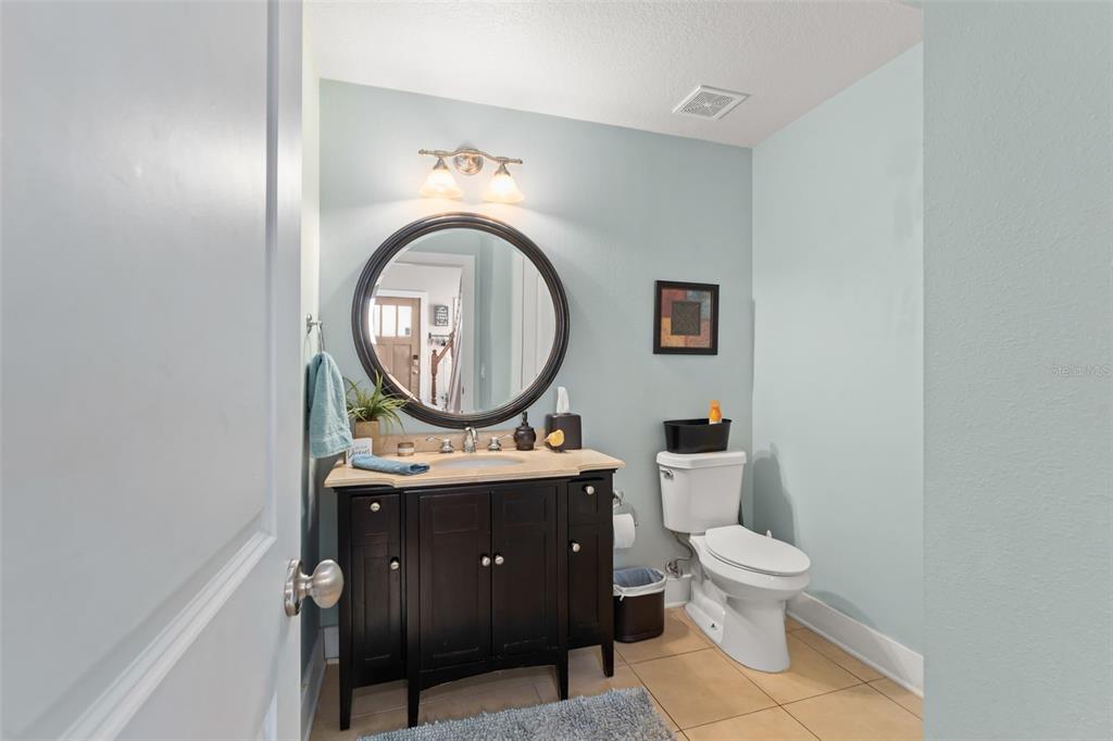 2223 Amherst Avenue Orlando, FL 32804 - Photo 15 of 64 a bathroom with a toilet a sink and a mirror