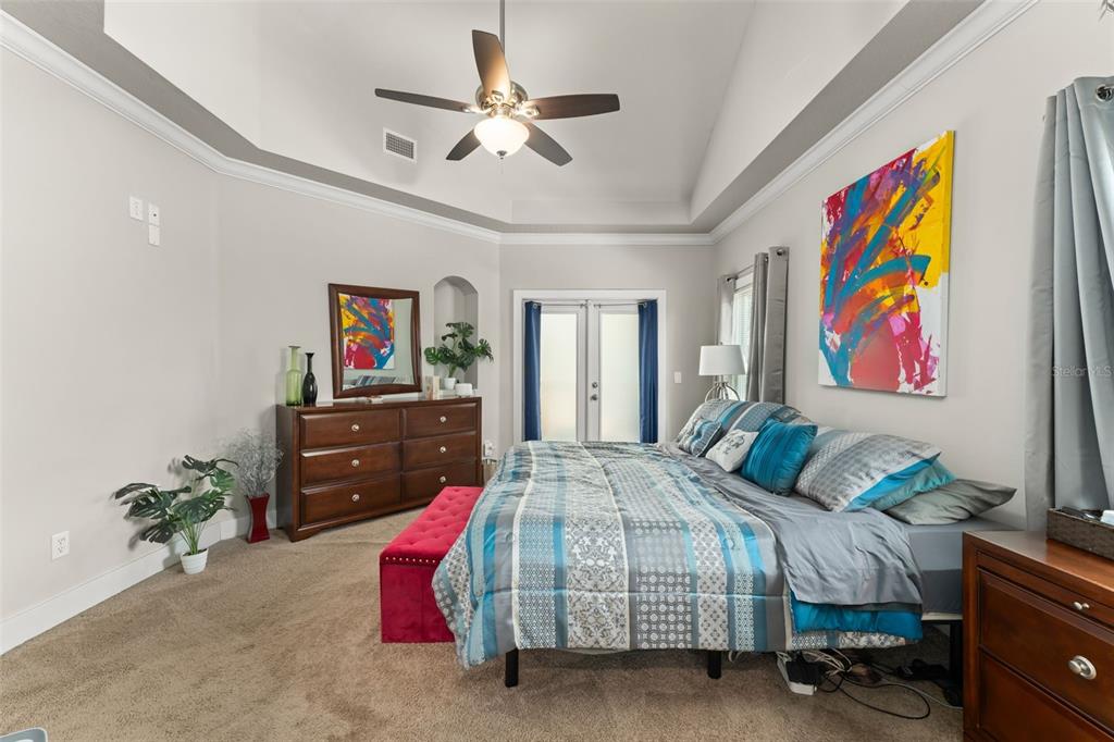 2223 Amherst Avenue Orlando, FL 32804 - Photo 21 of 64 a bedroom with a bed and a chandelier