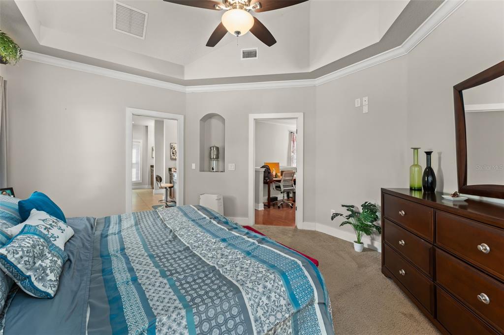 2223 Amherst Avenue Orlando, FL 32804 - Photo 23 of 64 a bedroom with a bed and wooden floor