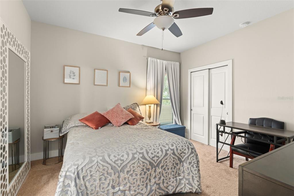 2223 Amherst Avenue Orlando, FL 32804 - Photo 27 of 64 a bedroom with a bed and a chandelier