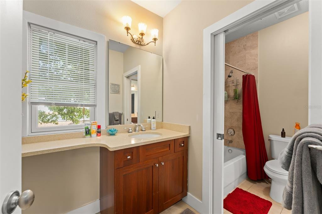2223 Amherst Avenue Orlando, FL 32804 - Photo 31 of 64 a bathroom with a sink a vanity and a mirror