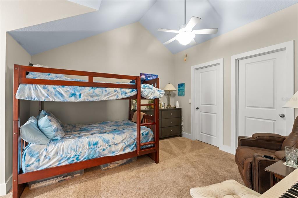 2223 Amherst Avenue Orlando, FL 32804 - Photo 32 of 64 a bedroom with a bed and a chandelier