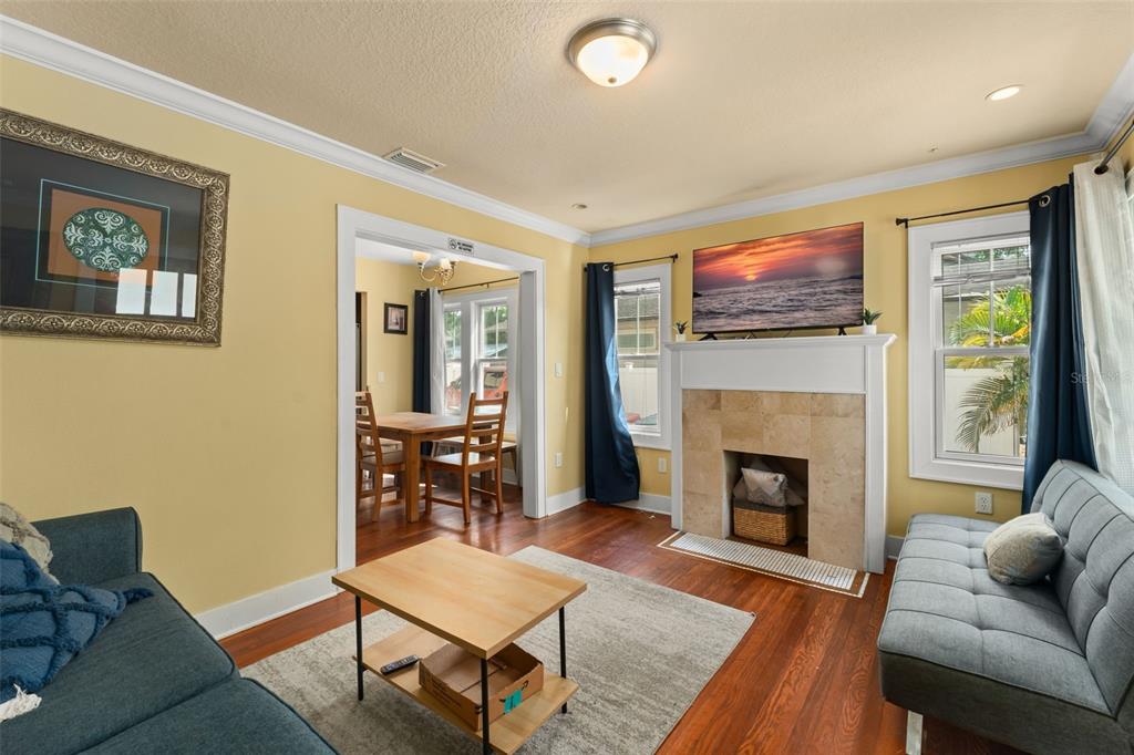 2223 Amherst Avenue Orlando, FL 32804 - Photo 38 of 64 a living room with furniture a flat screen tv and a fireplace