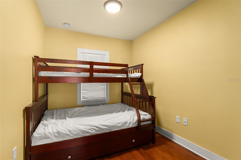 2223 Amherst Avenue Orlando, FL 32804 - Photo 41 of 64 a bedroom with a bed and wooden floor