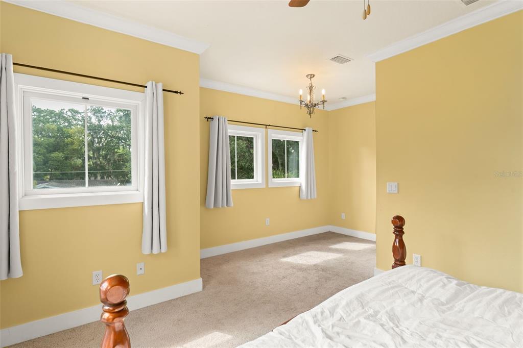 2223 Amherst Avenue Orlando, FL 32804 - Photo 48 of 64 a bedroom with a bed and a window