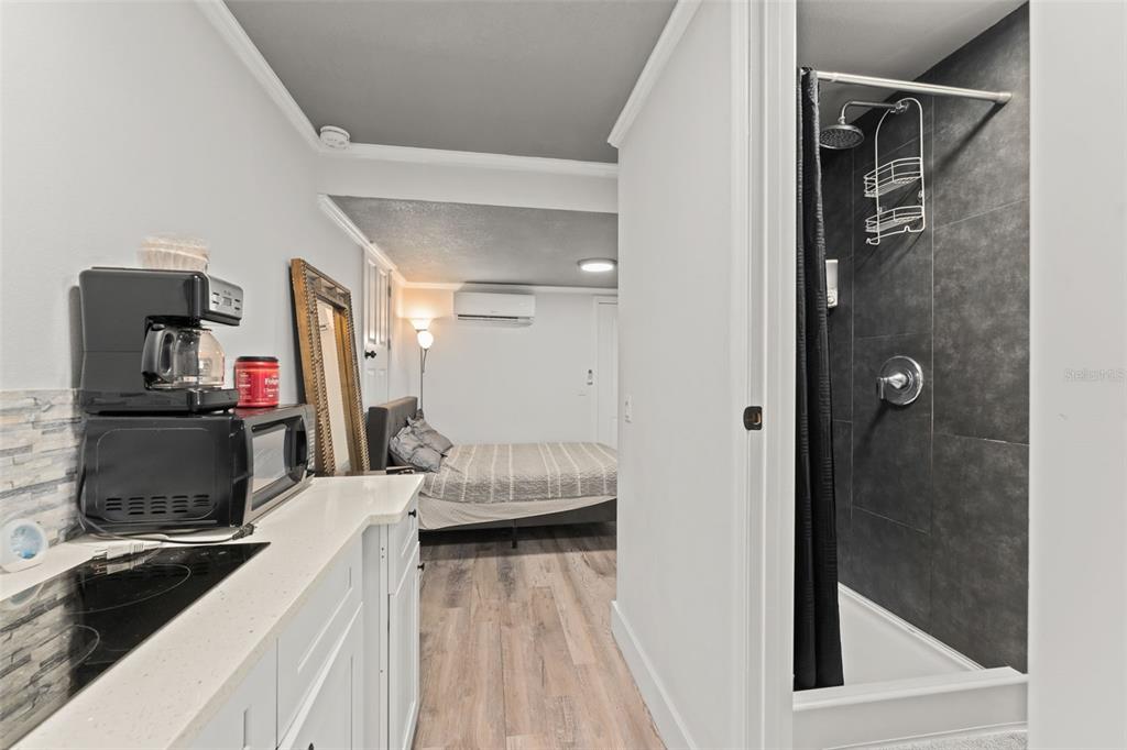 2223 Amherst Avenue Orlando, FL 32804 - Photo 54 of 64 a living room with a bed and a refrigerator