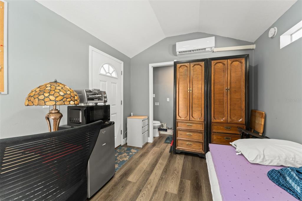 2223 Amherst Avenue Orlando, FL 32804 - Photo 61 of 64 a bedroom with furniture and a wooden floor