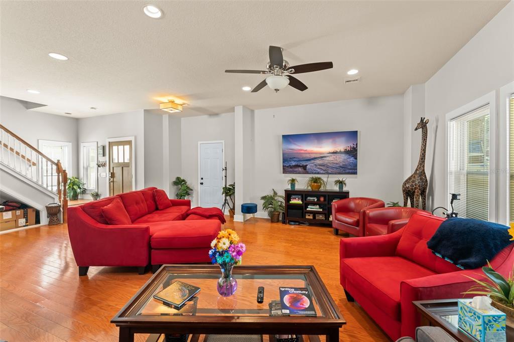 2223 Amherst Avenue Orlando, FL 32804 - Photo 8 of 64 a living room with furniture a red rug and a chandelier