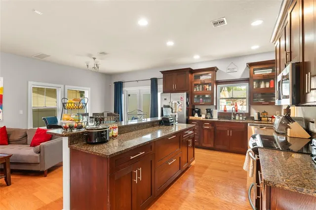 a kitchen with stainless steel appliances granite countertop a refrigerator and a stove