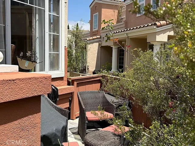 a view of a house with a tree and plants