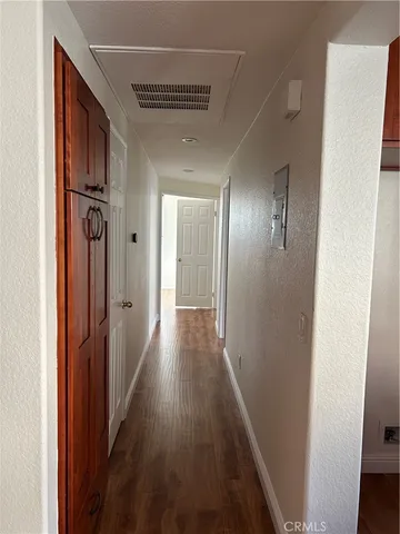 a view of hallway with wooden floor