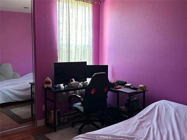 a bedroom with a bed and a desk