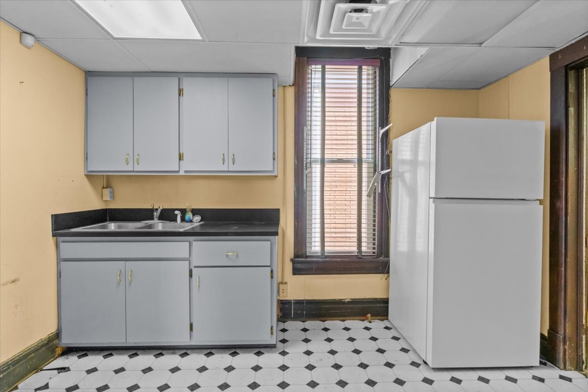 203 East Main Street Waverly, TN 37185 - Photo 13 of 32 a kitchen with granite countertop a refrigerator and a sink