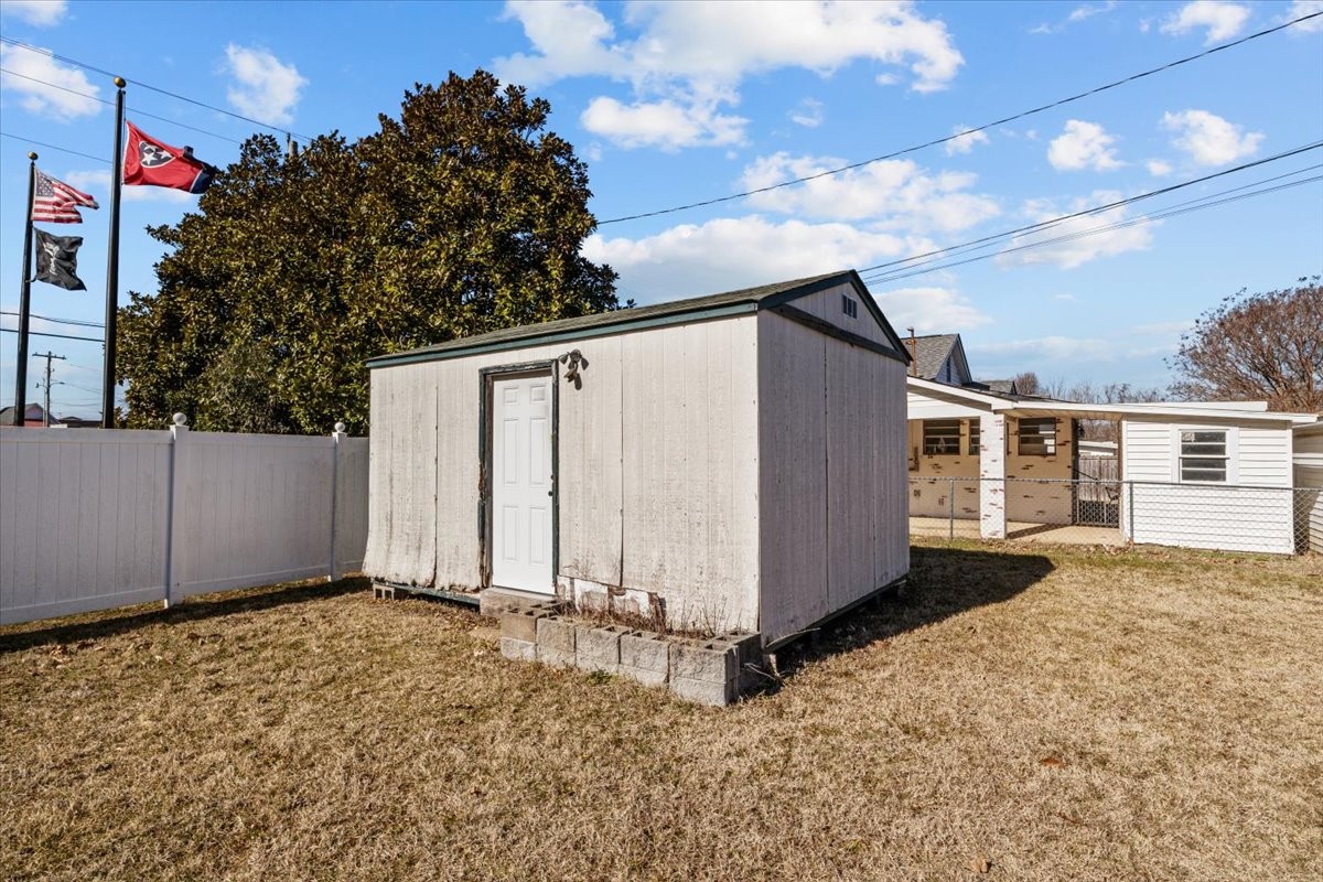 203 East Main Street Waverly, TN 37185 - Photo 27 of 32 a backyard of a house with wooden fence