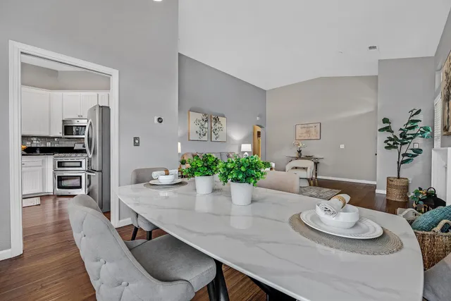 a view of a dining room with furniture and wooden floor