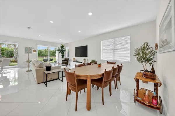a view of a dining room with furniture and a potted plant