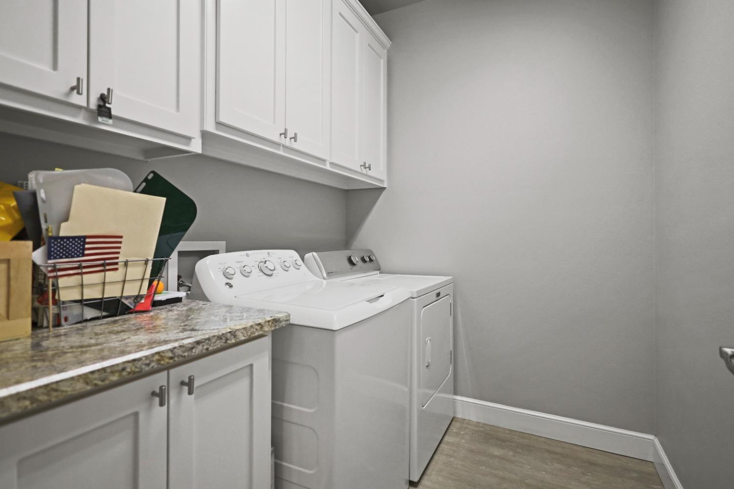 5227 Lehigh Street Lubbock, TX 79416 - Photo 26 of 33 a utility room with granite countertop cabinets and sink