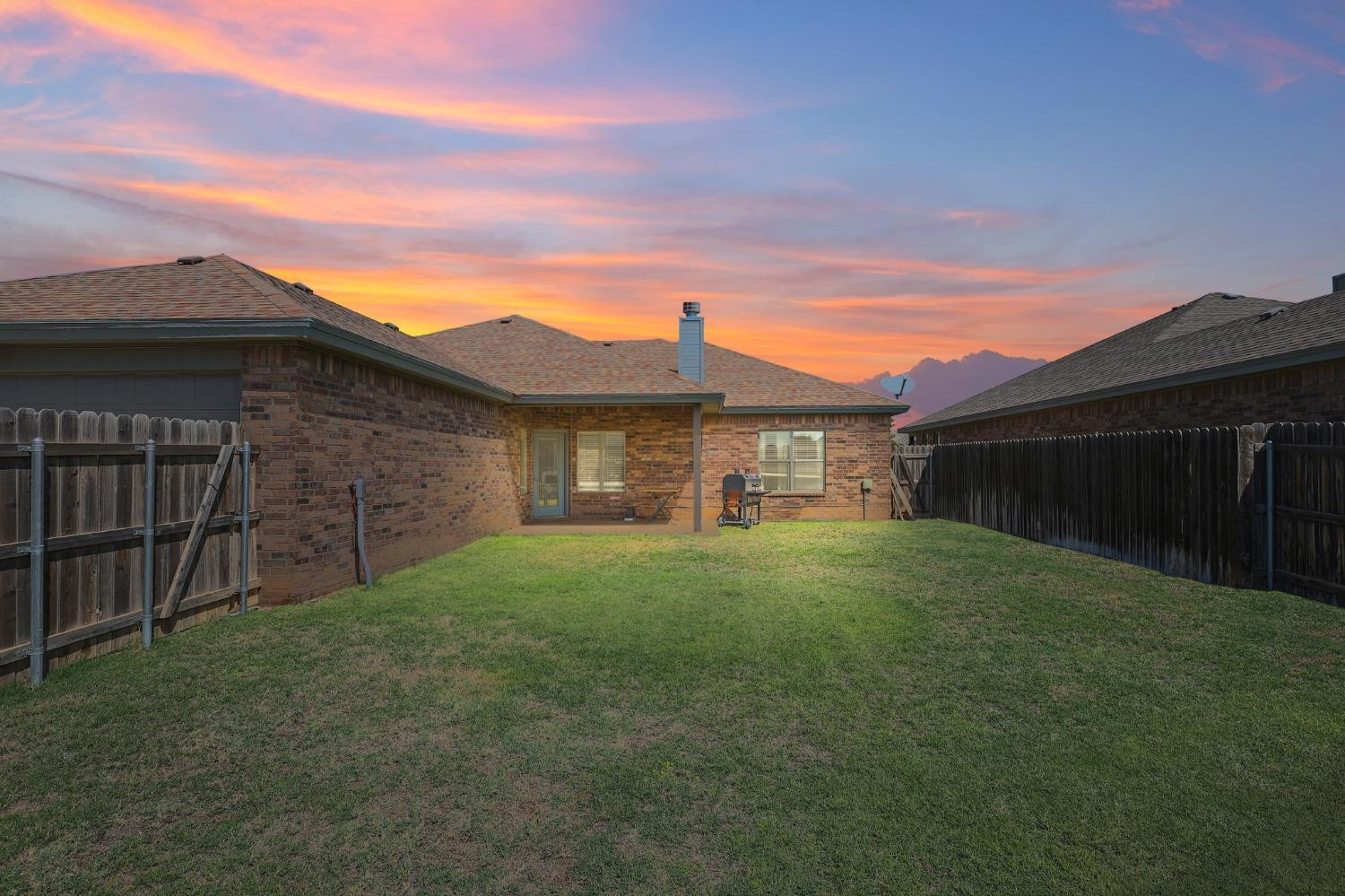 5227 Lehigh Street Lubbock, TX 79416 - Photo 31 of 33 a view of a yard in front of a house with a large tree