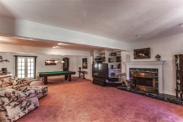 19 Rutgers Road Andover, MA 01810 - Photo 20 of 26 a living room with furniture a fireplace and gym equipment