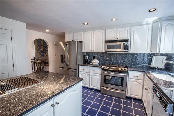 19 Rutgers Road Andover, MA 01810 - Photo 8 of 26 a kitchen with kitchen island granite countertop a stove sink and cabinets