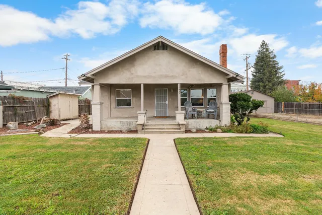 a view of a house with a yard patio and swimming pool