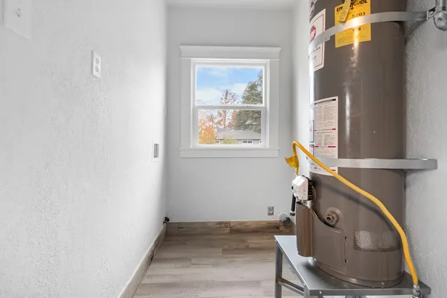 a utility room with dryer and window