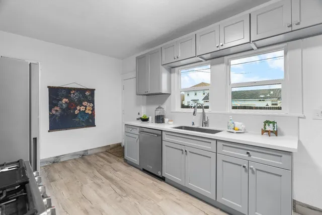 a kitchen with a sink cabinets and window