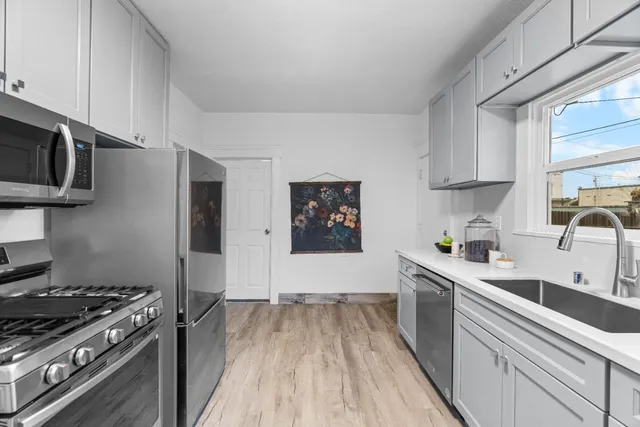 a kitchen with stainless steel appliances a sink a stove and cabinets