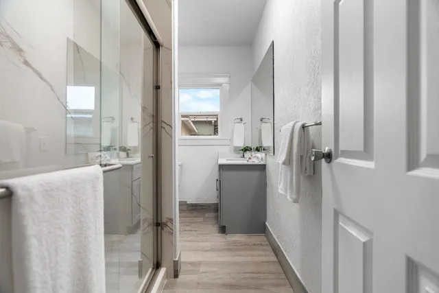 a bathroom with a shower and a sink