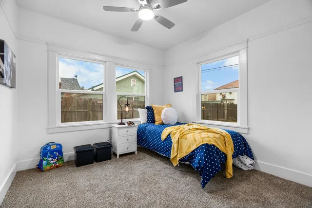 a bed sitting in a room next to a window