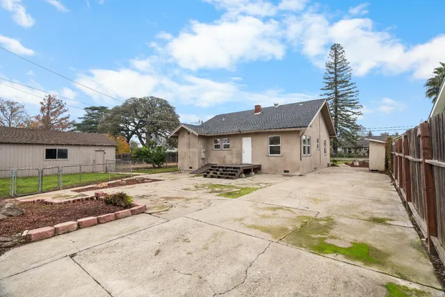 a view of a house with table and chair in the patio