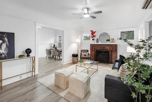 a living room with furniture a fireplace and a potted plant