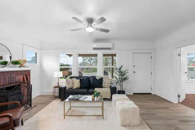 a living room with furniture a fireplace and a flat screen tv