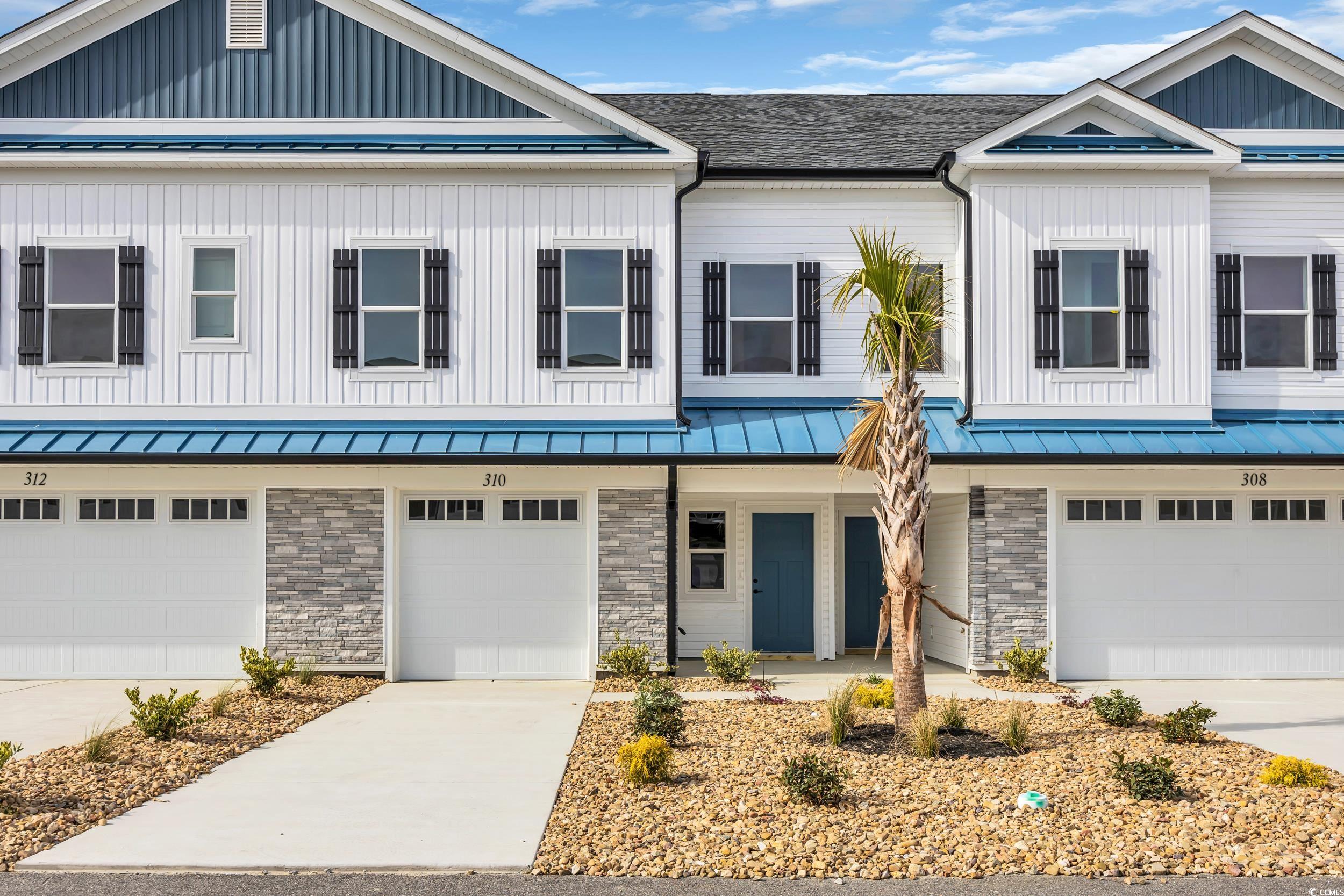 315 Lineback Place, Unit 37 Longs, SC 29568 - Photo 6 of 39 Townhome / multi-family property with a standing seam roof, metal roof, stone siding, and a garage