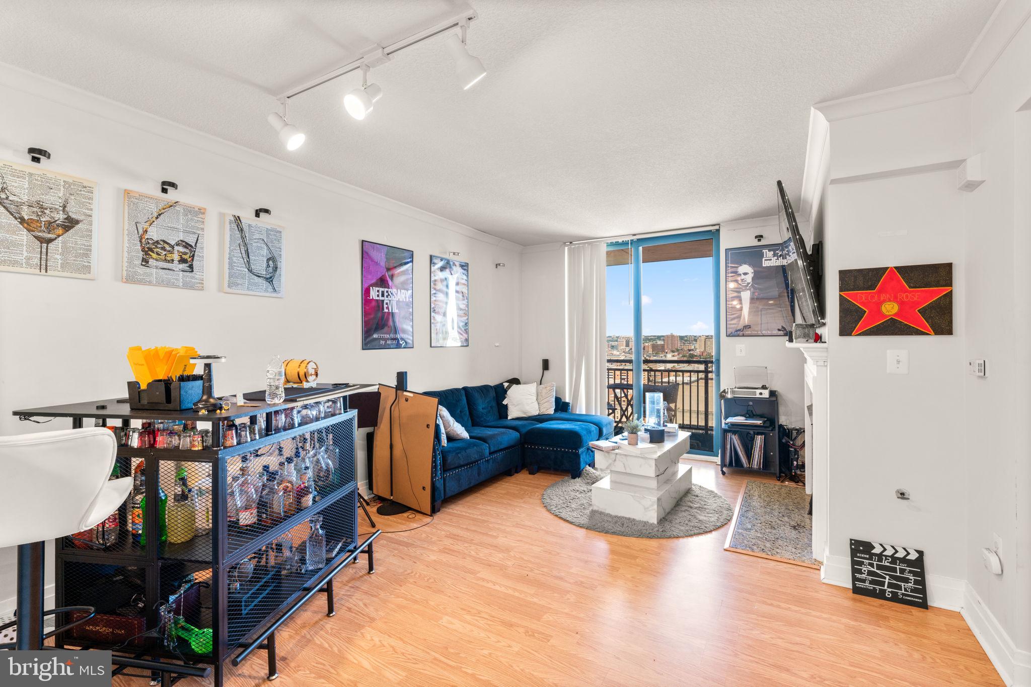 414 Water Street, Unit 2311 Baltimore, MD 21202 - Photo 11 of 44 a living room with fireplace furniture and a window
