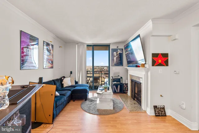 a living room with furniture a fireplace and a table