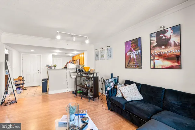 a living room with furniture and kitchen view