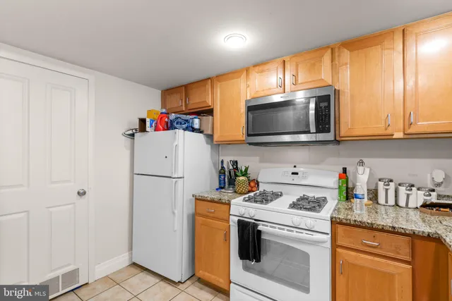 a kitchen with stainless steel appliances granite countertop a refrigerator sink microwave and cabinets