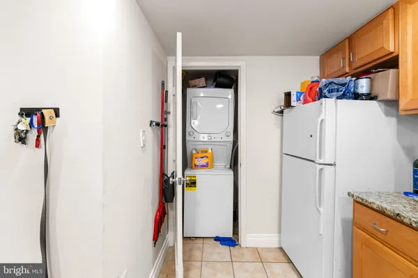 a white refrigerator freezer and a wooden floor