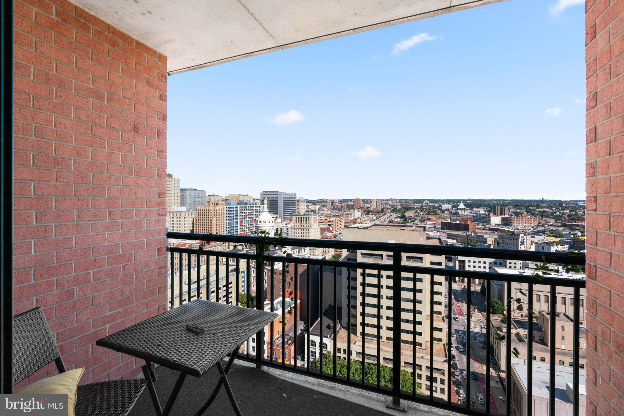 414 Water Street, Unit 2311 Baltimore, MD 21202 - Photo 30 of 44 a view of a balcony with wooden benches