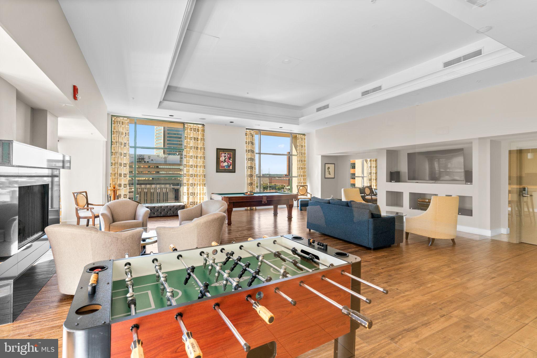 414 Water Street, Unit 2311 Baltimore, MD 21202 - Photo 36 of 44 a living room with fireplace furniture and a large window