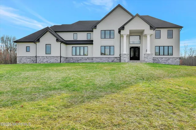 a front view of a house with a garden and yard