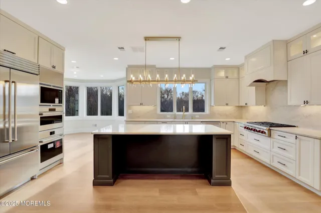a kitchen that has a sink a stove and a wooden floor