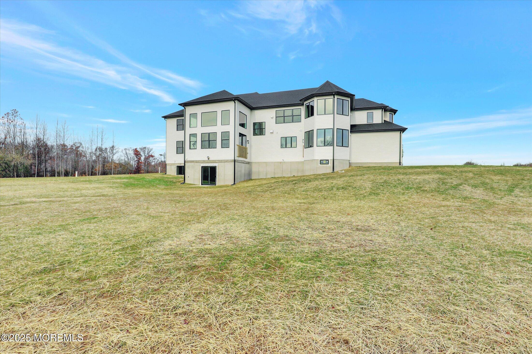 5 Cook Court Millstone Township, NJ 08535 - Photo 24 of 58 a view of a big house with a big yard and large trees